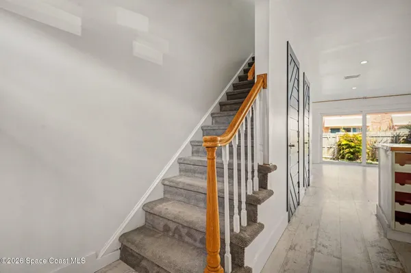 a view of entryway and hall with wooden floor