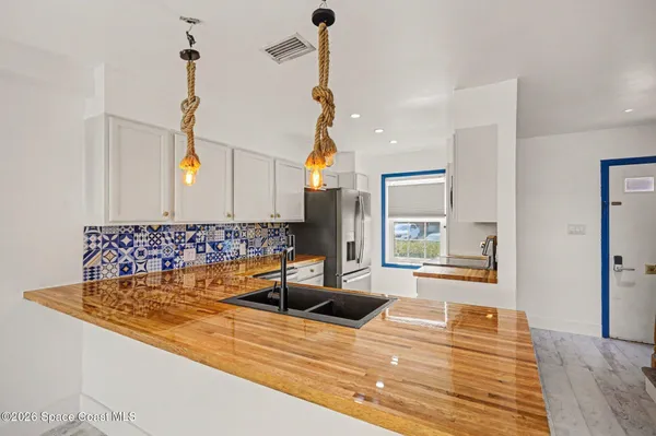 a view of kitchen and empty room