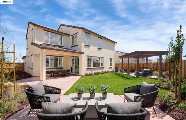 a view of a house with backyard sitting area and swimming pool