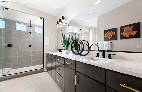 a bathroom with a sink a mirror and a shower