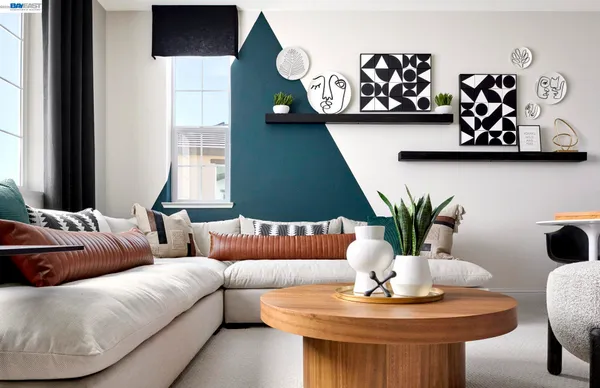 a living room with furniture and potted plant