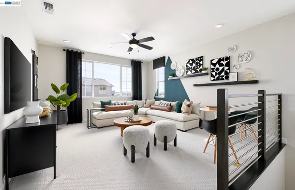 a living room with furniture potted plant and a flat screen tv