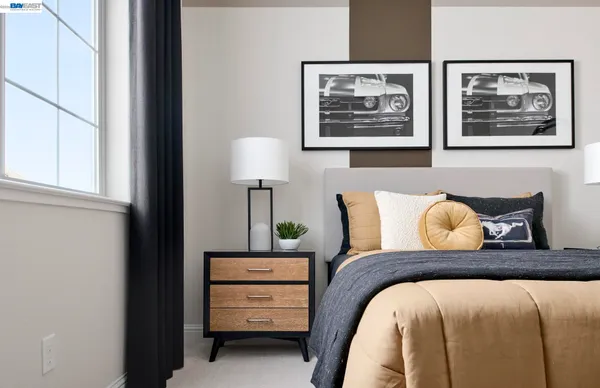 a bedroom with furniture and a window