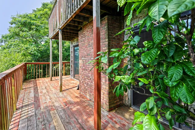 a living room with furniture large windows and a fireplace