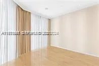 a view of a closet with wooden floor