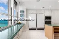 a kitchen with stainless steel appliances kitchen island granite countertop a stove and a refrigerator