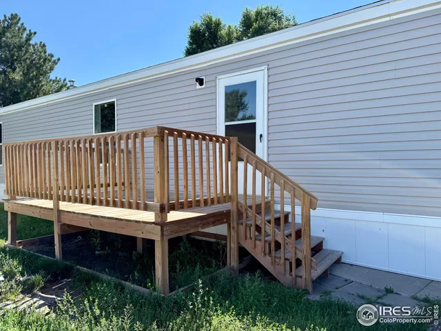 a view of a wooden deck with a small yard