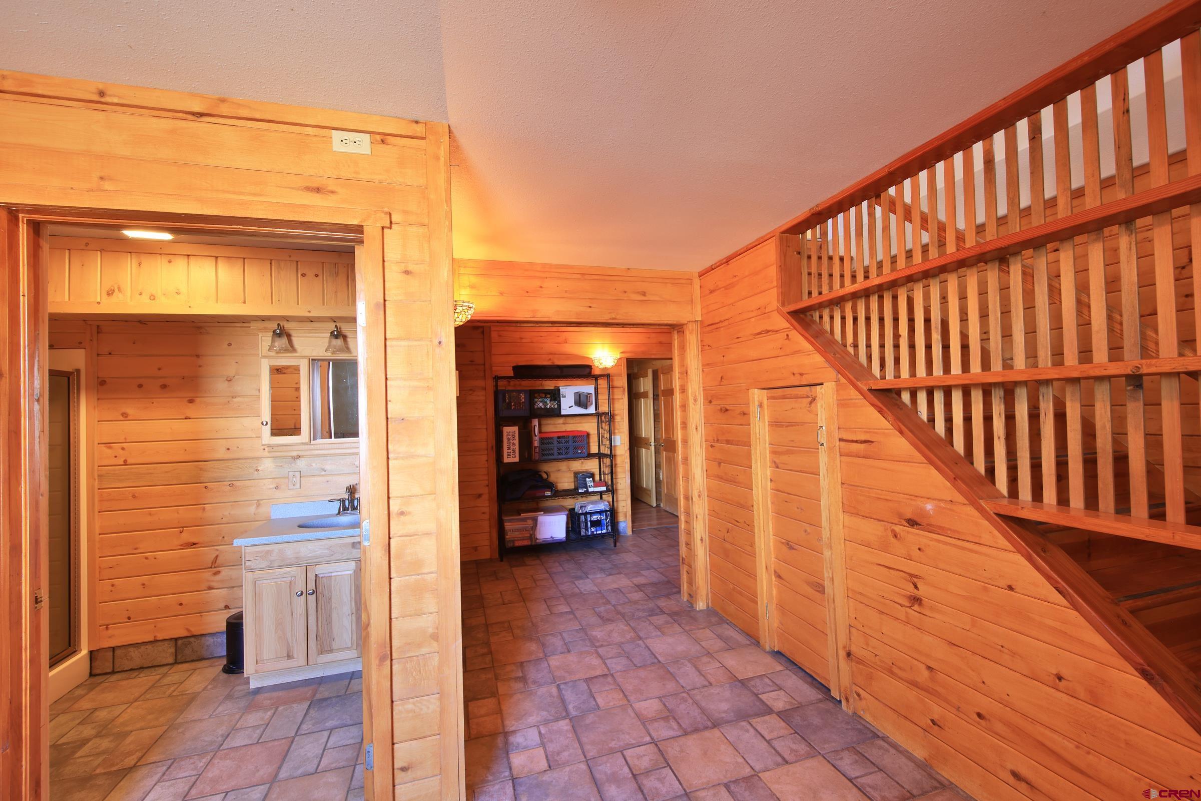10822 60 75/100 Road Collbran, CO 81624 - Photo 23 of 45 a view of hallway with wooden floor and stairs