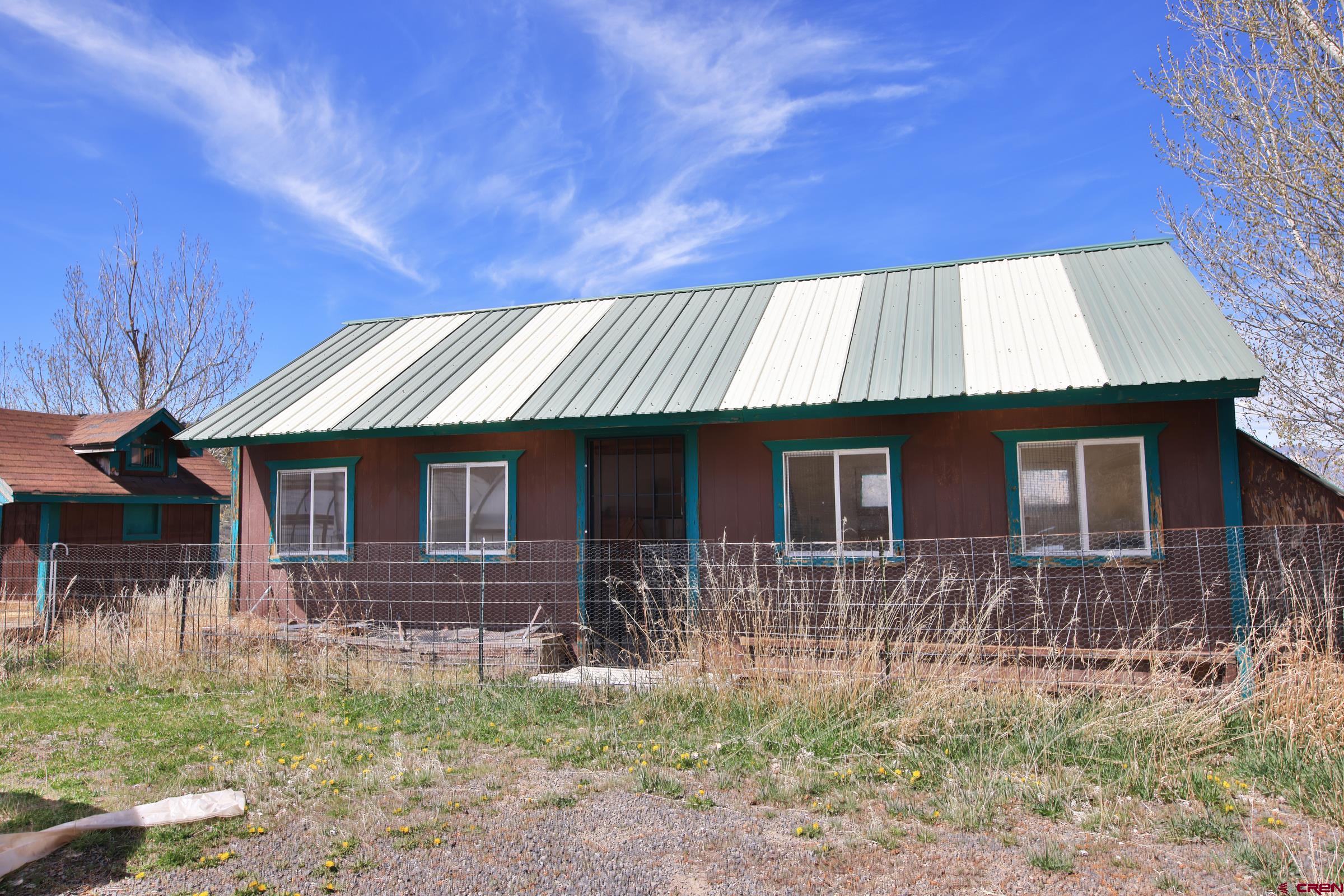 10822 60 75/100 Road Collbran, CO 81624 - Photo 32 of 45 a front view of house with yard