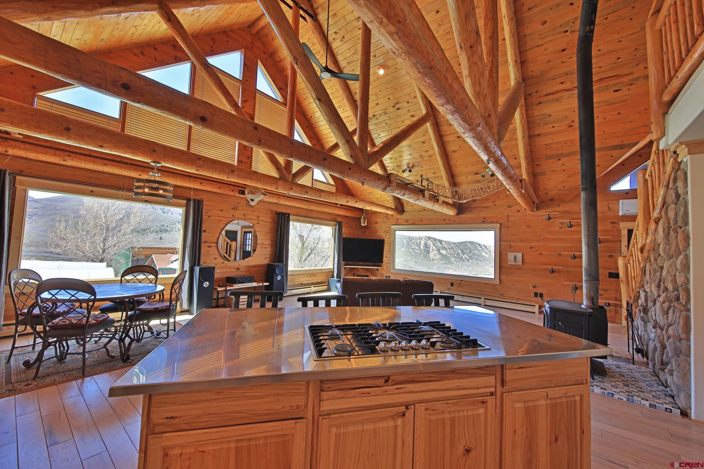 10822 60 75/100 Road Collbran, CO 81624 - Photo 10 of 45 a kitchen with stainless steel appliances granite countertop a stove and a wooden cabinets