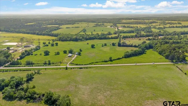 an aerial view of ocean with residential houses with outdoor space
