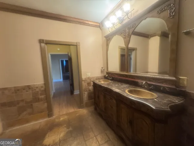 a bathroom with a granite countertop bathtub shower sink and toilet
