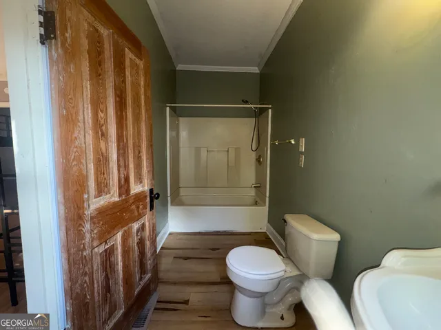 a bathroom with a toilet and shower