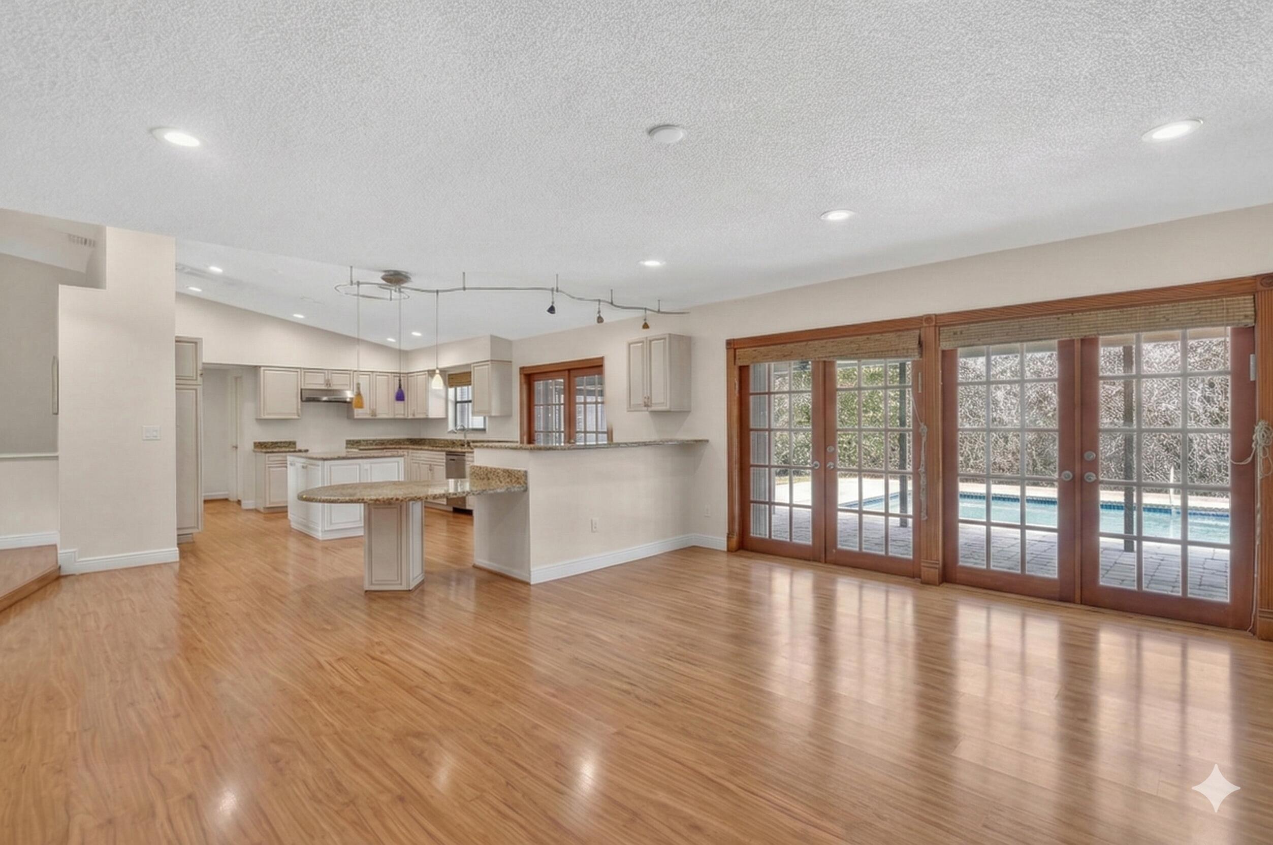 22220 Morning Glory Terrace Boca Raton, FL 33433 - Photo 11 of 69 a view of a kitchen with kitchen island wooden floors and stainless steel appliances