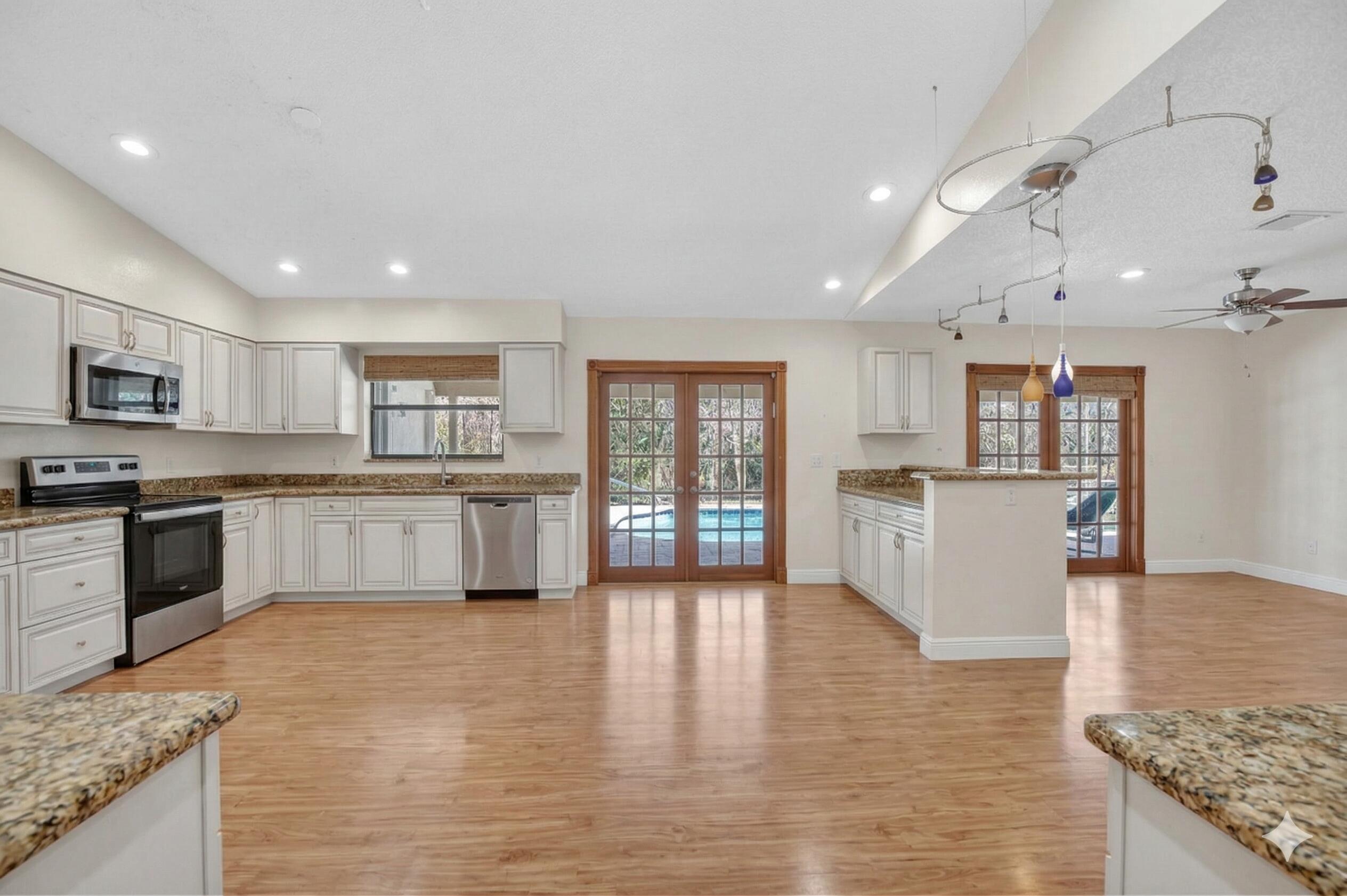 22220 Morning Glory Terrace Boca Raton, FL 33433 - Photo 14 of 69 a large kitchen with cabinets wooden floor and stainless steel appliances
