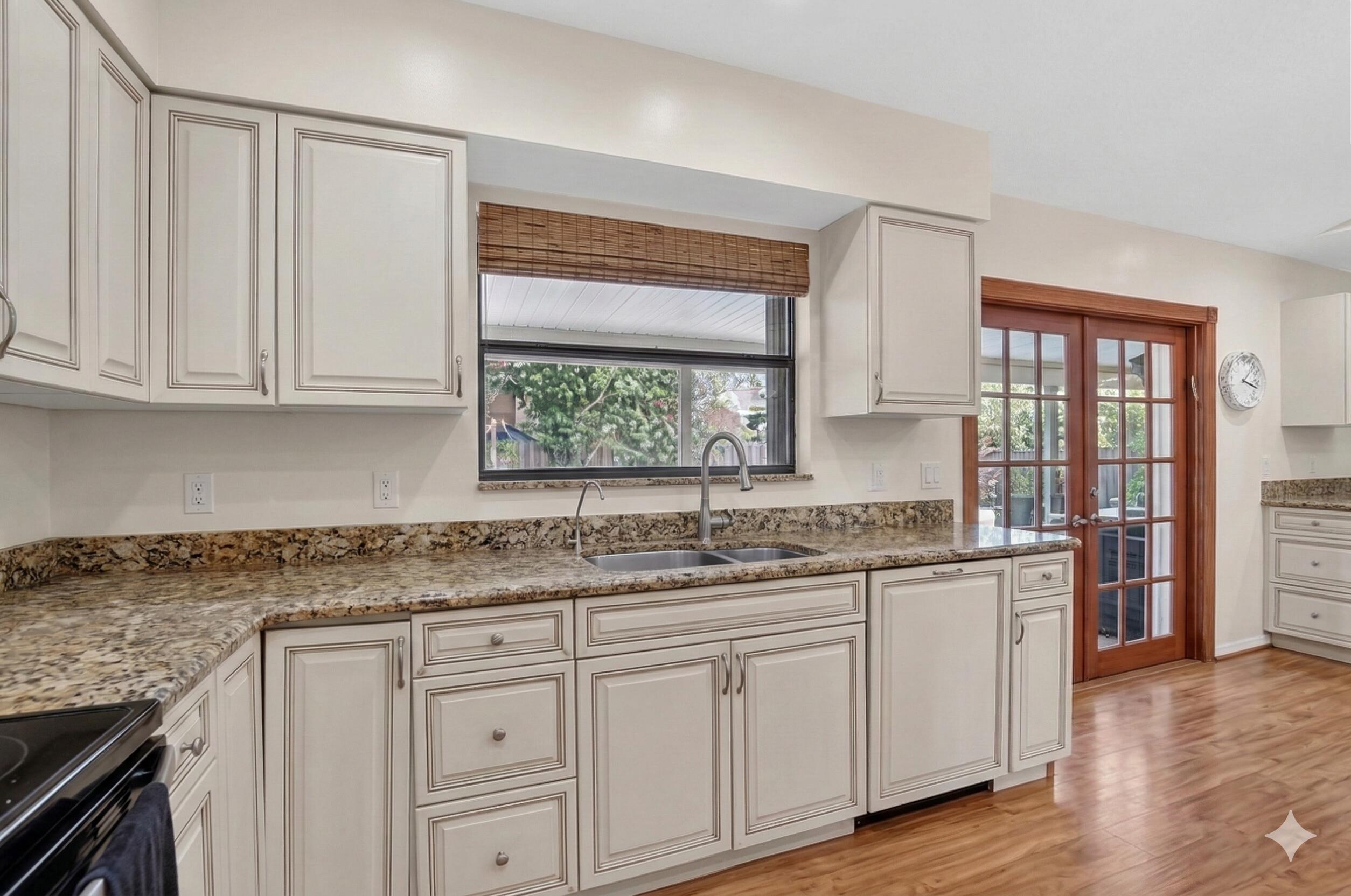 22220 Morning Glory Terrace Boca Raton, FL 33433 - Photo 17 of 69 a kitchen with stainless steel appliances granite countertop a sink and cabinets with wooden floor