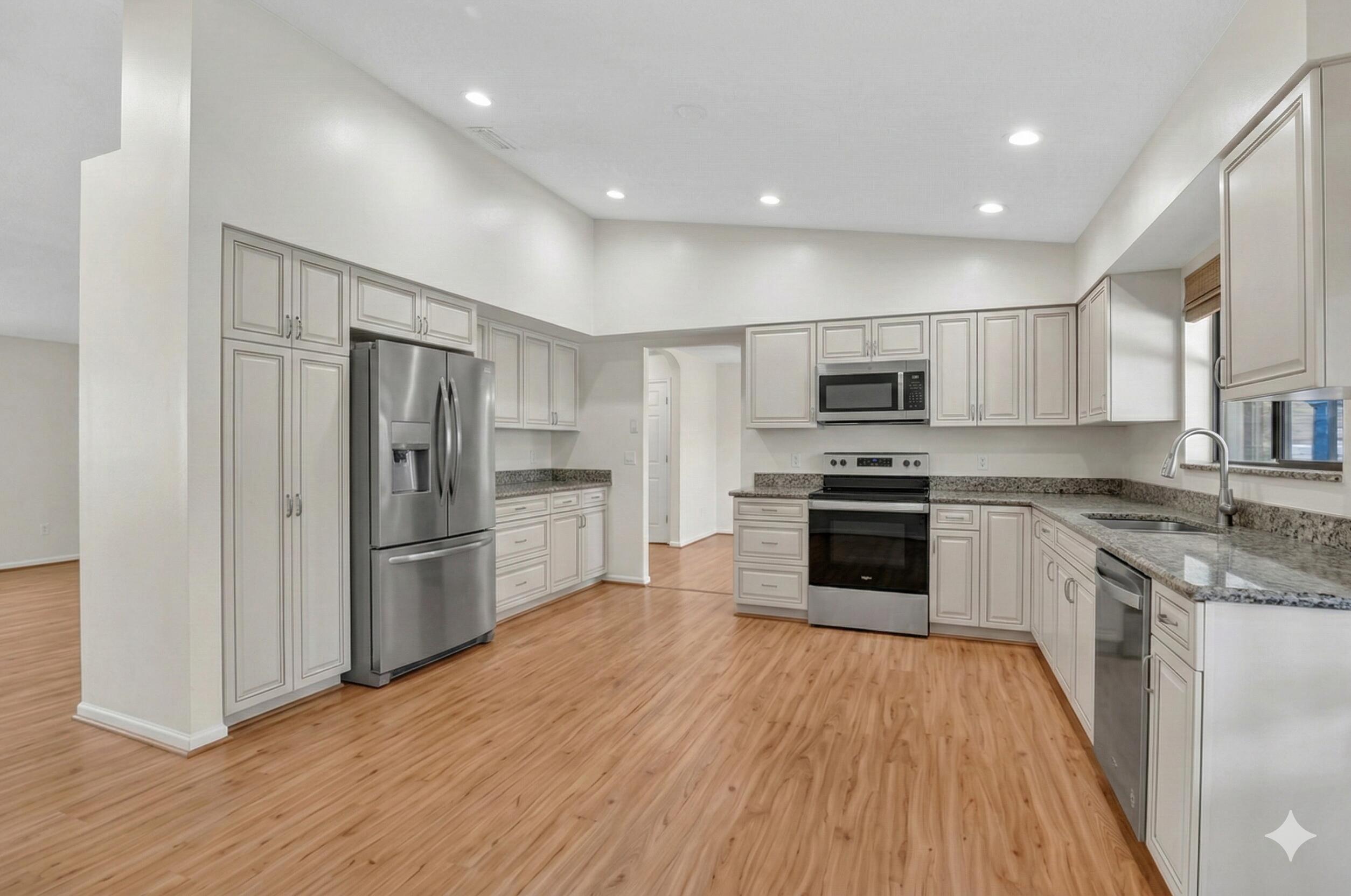 22220 Morning Glory Terrace Boca Raton, FL 33433 - Photo 18 of 69 a kitchen with granite countertop a refrigerator and a stove top oven
