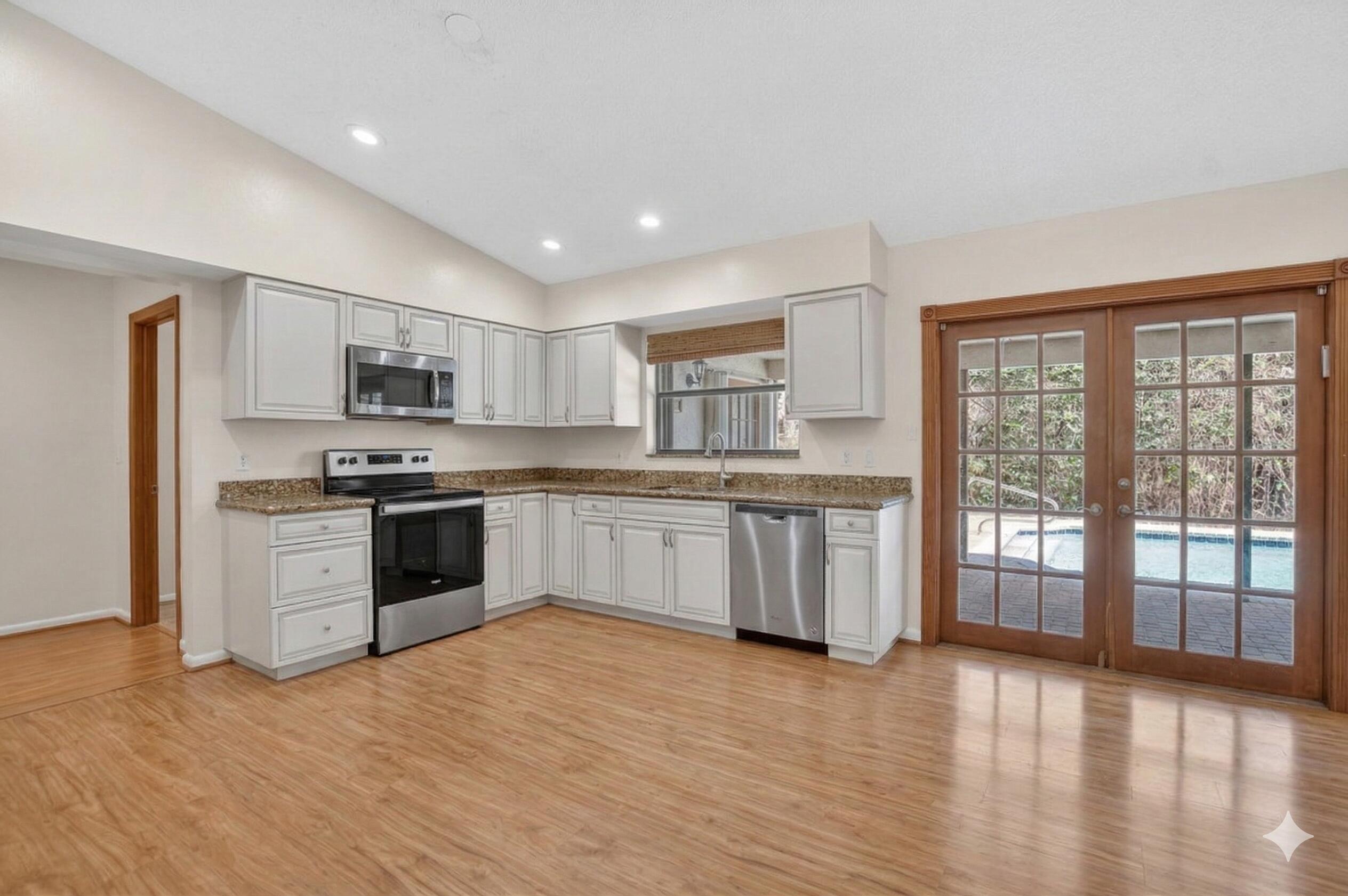 22220 Morning Glory Terrace Boca Raton, FL 33433 - Photo 20 of 69 a kitchen with stainless steel appliances granite countertop a stove top oven a sink and a refrigerator