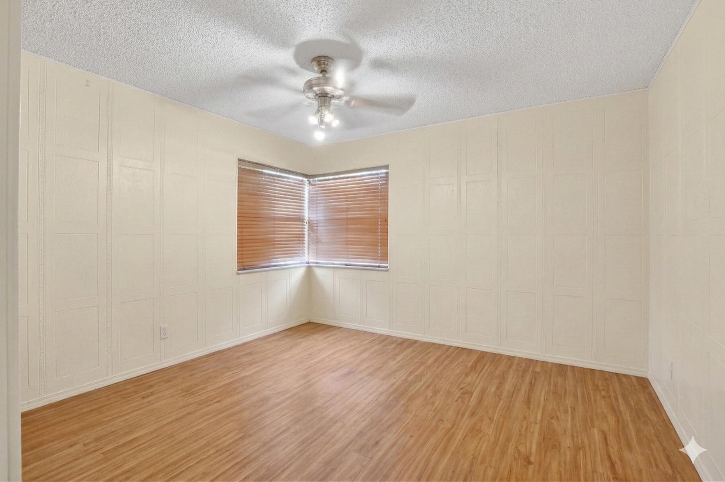 22220 Morning Glory Terrace Boca Raton, FL 33433 - Photo 22 of 69 a view of an empty room with wooden floor and a window