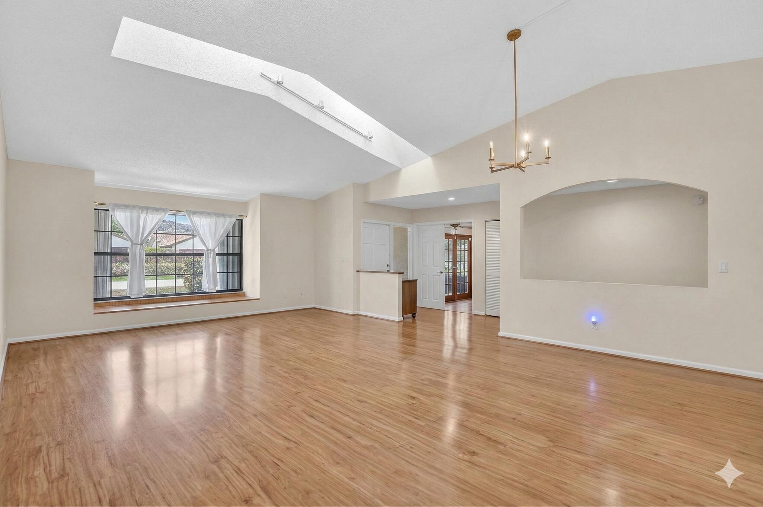 22220 Morning Glory Terrace Boca Raton, FL 33433 - Photo 64 of 69 a view of an empty room with wooden floor and a window