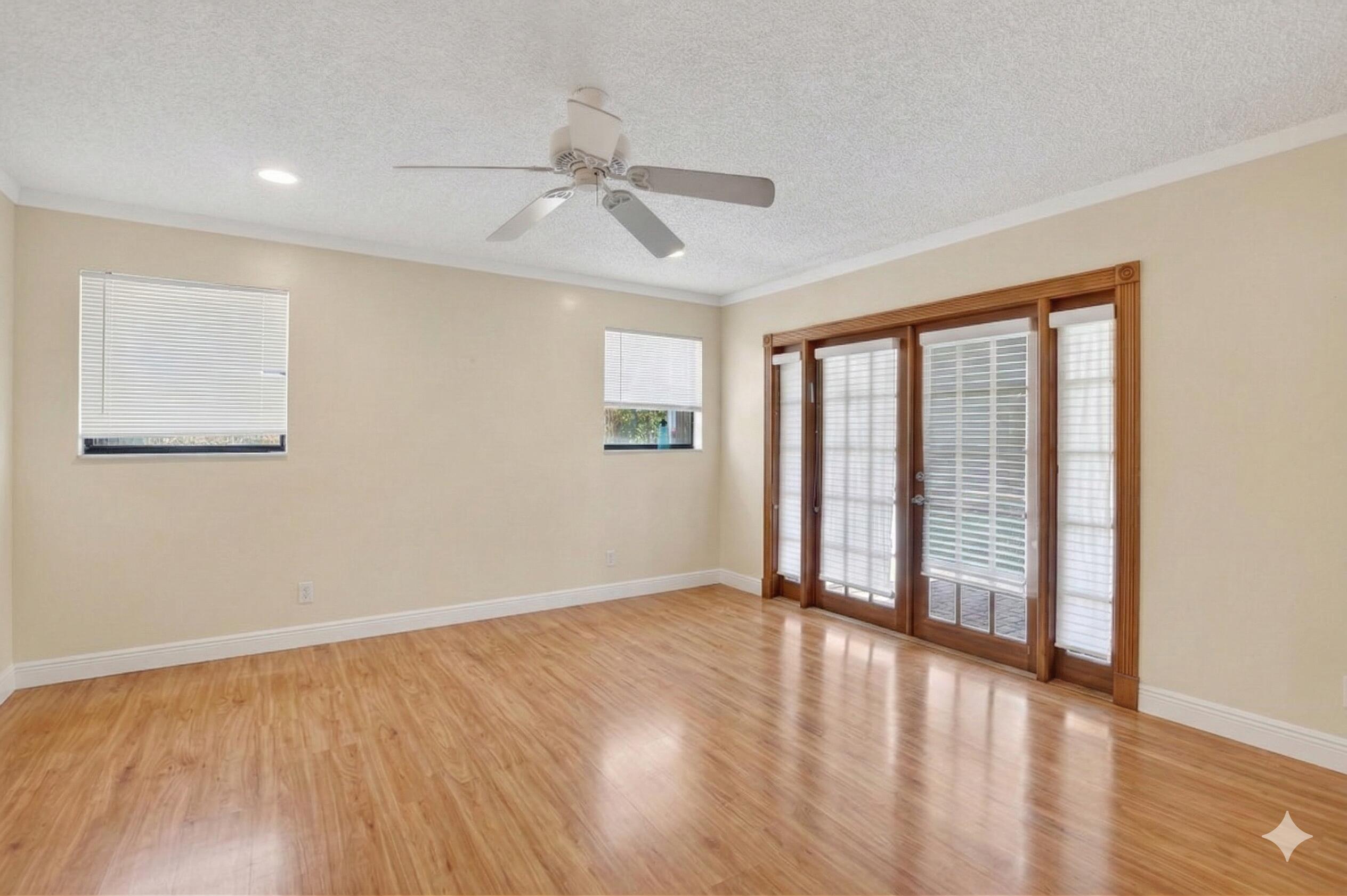 22220 Morning Glory Terrace Boca Raton, FL 33433 - Photo 66 of 69 a view of an empty room with wooden floor and a window
