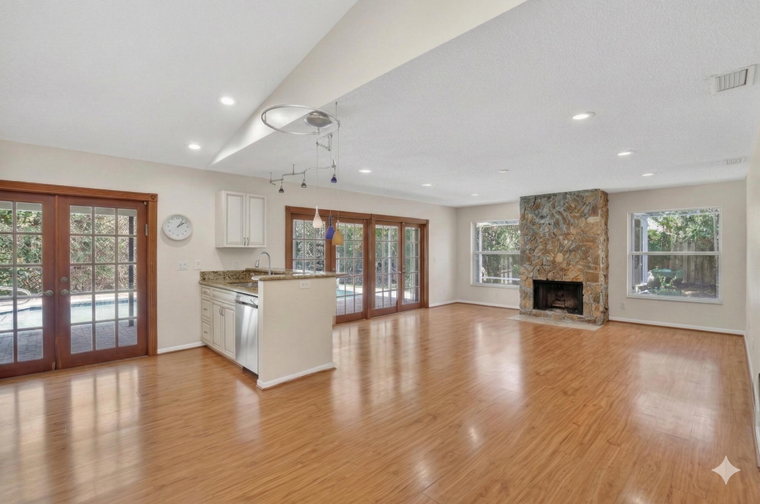 22220 Morning Glory Terrace Boca Raton, FL 33433 - Photo 9 of 69 an empty room with wooden floor and fireplace