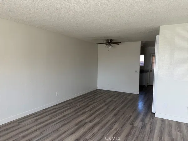 a view of a room with wooden floor and white walls