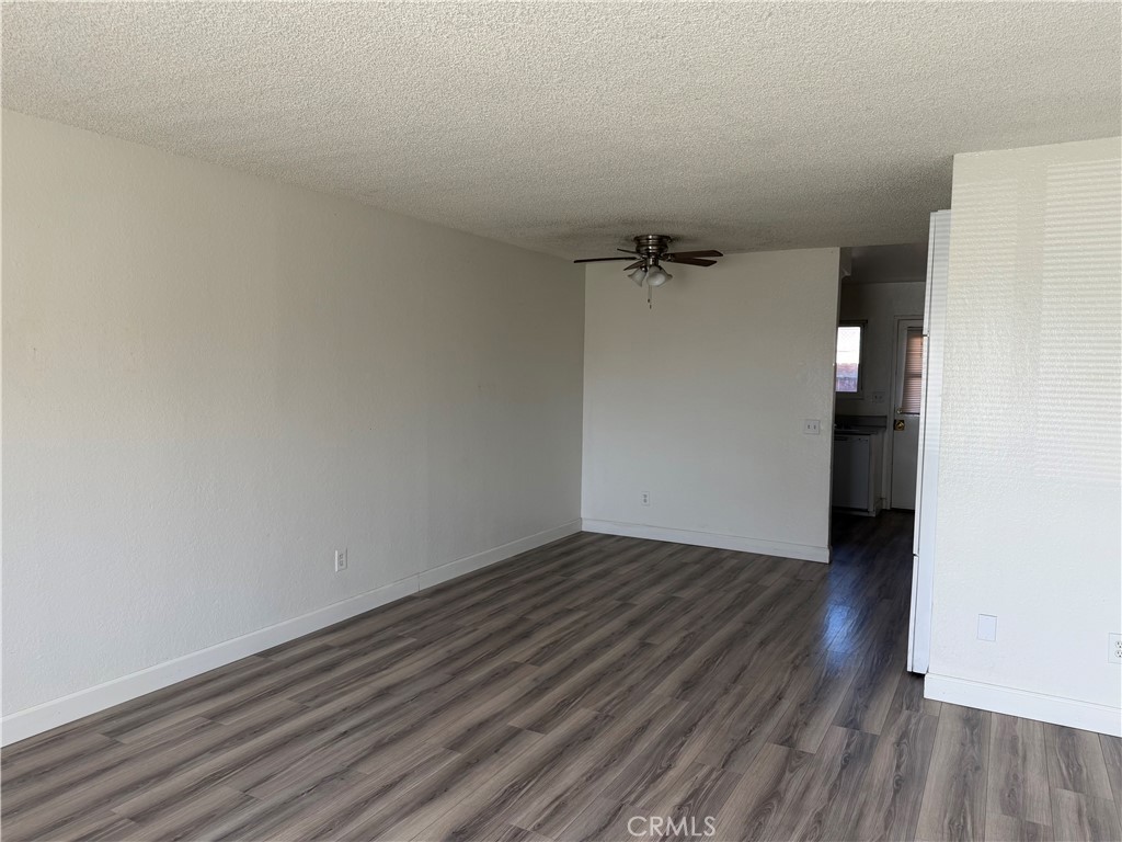 7405 Napa Court Rancho Cucamonga, CA 91730 - Photo 2 of 9 a view of a room with wooden floor and white walls