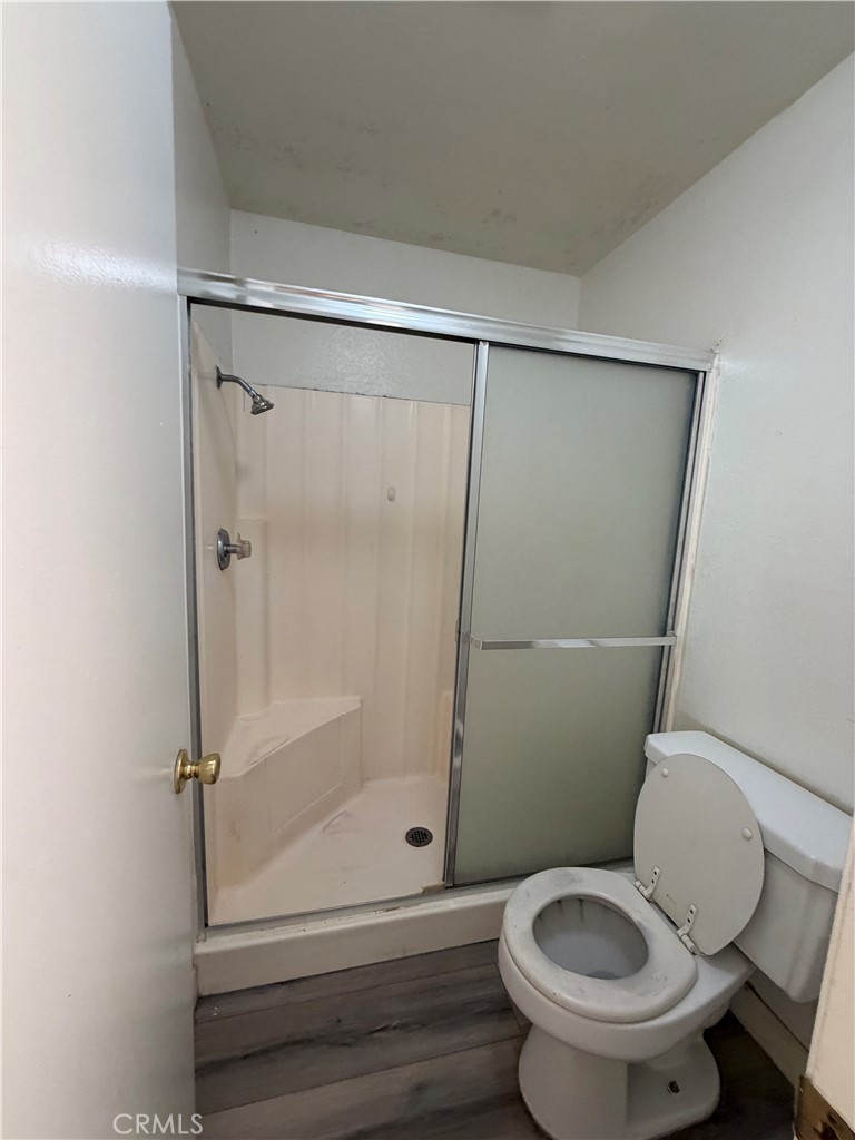 7405 Napa Court Rancho Cucamonga, CA 91730 - Photo 8 of 9 a white toilet sitting next to a shower