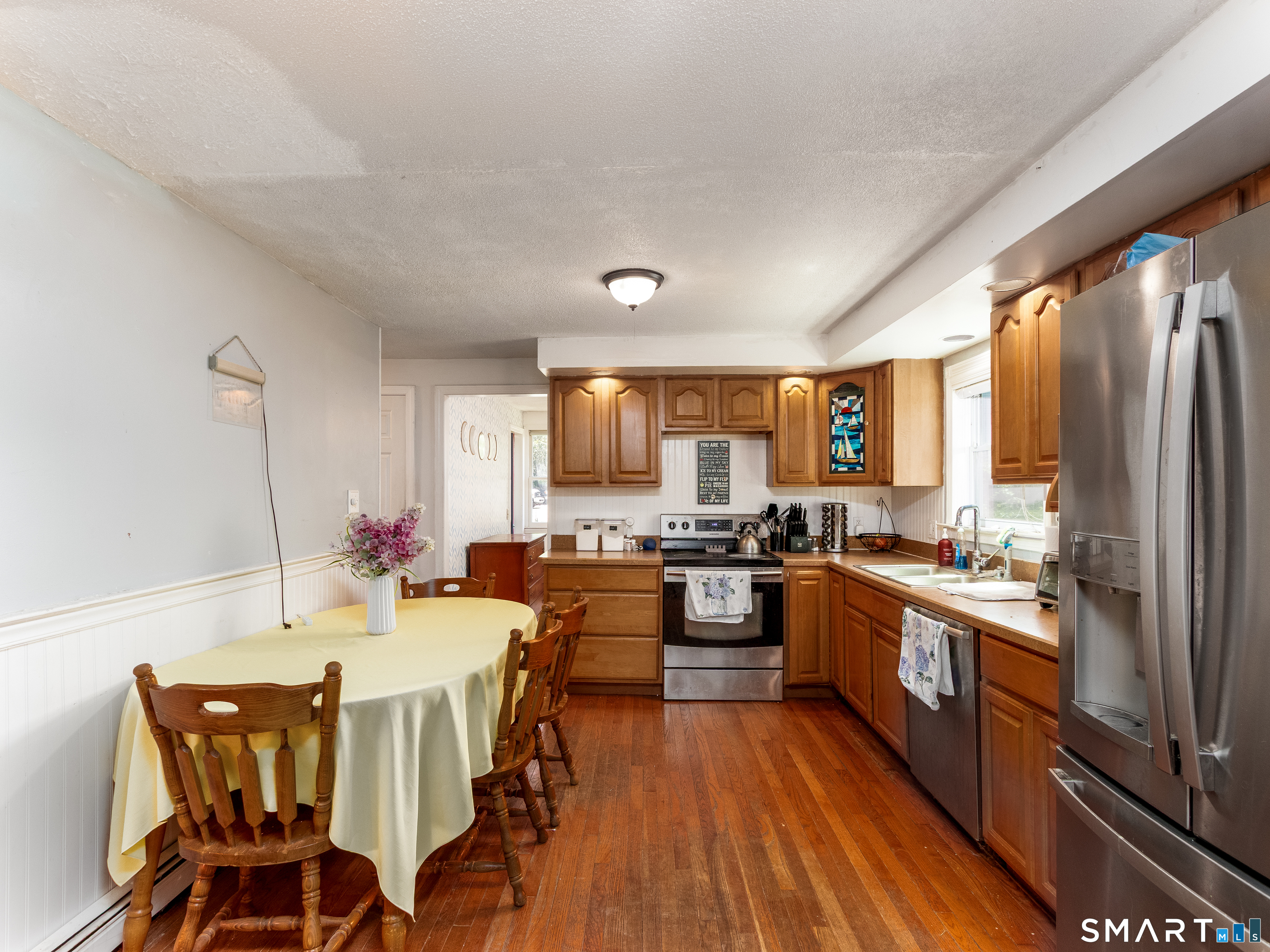 15 Bluff Avenue Clinton, CT 06413 - Photo 13 of 38 a large kitchen with a table and chairs