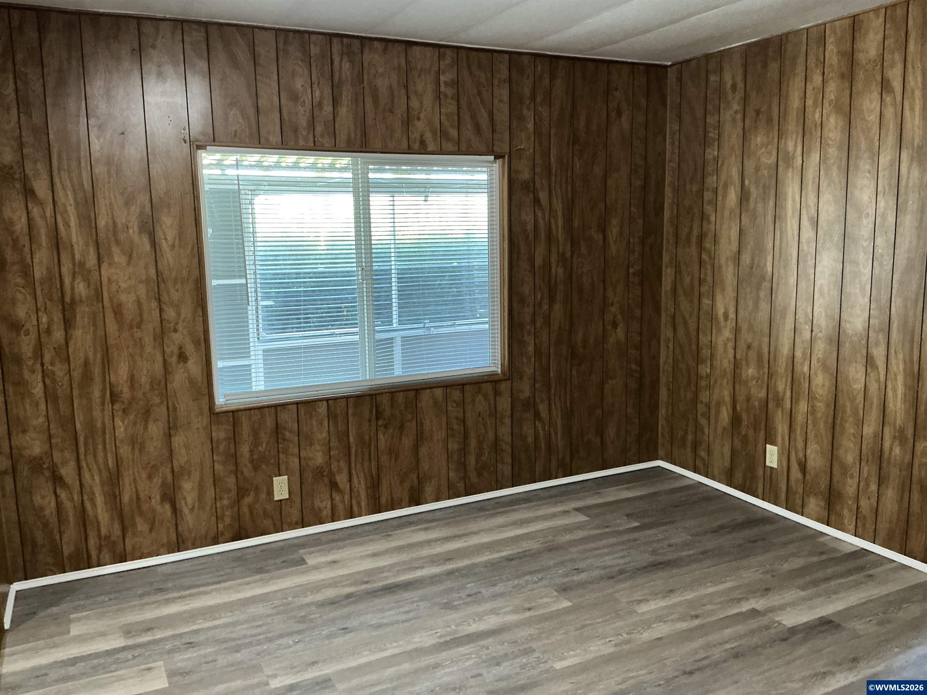5422 Portland Road Northeast, Unit 67 Salem, OR 97305 - Photo 32 of 45 an empty room with wooden floor and windows