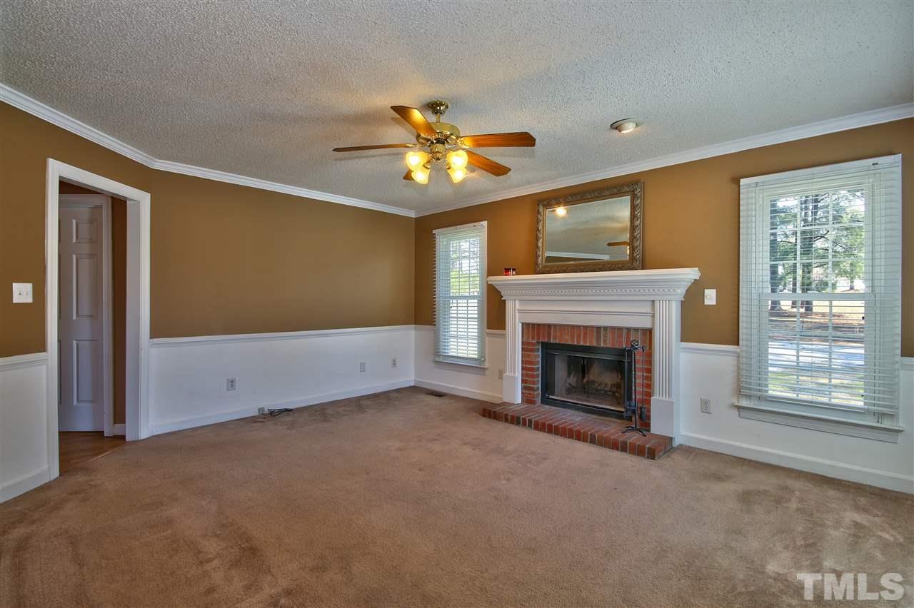 2937 Old Crews Road Raleigh, NC 27616 - Photo 2 of 19 a view of empty room with fireplace and fan