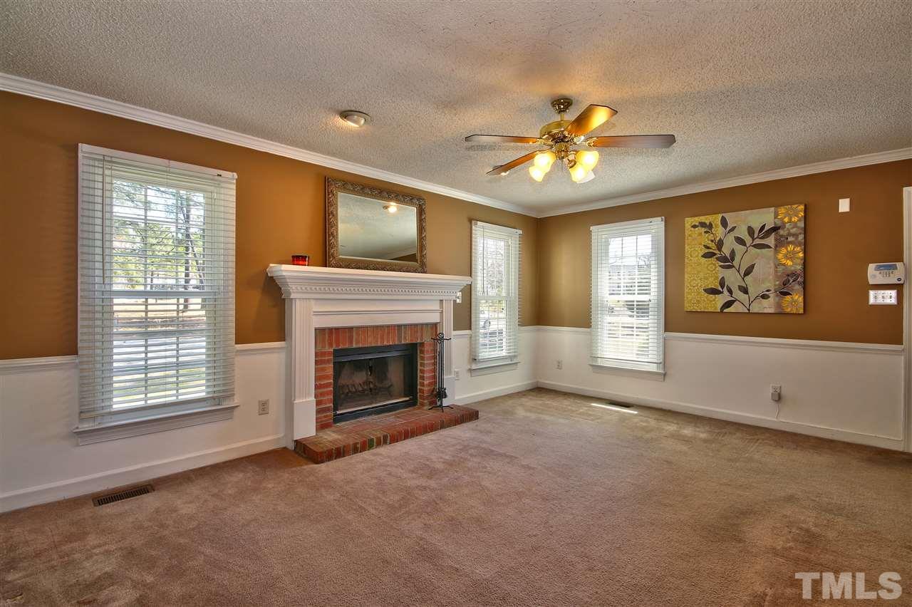 2937 Old Crews Road Raleigh, NC 27616 - Photo 3 of 19 a view of empty room with a fireplace and fan