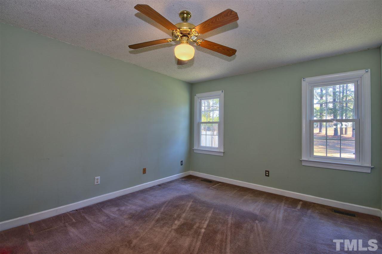 2937 Old Crews Road Raleigh, NC 27616 - Photo 4 of 19 an empty room with windows and ceiling fan