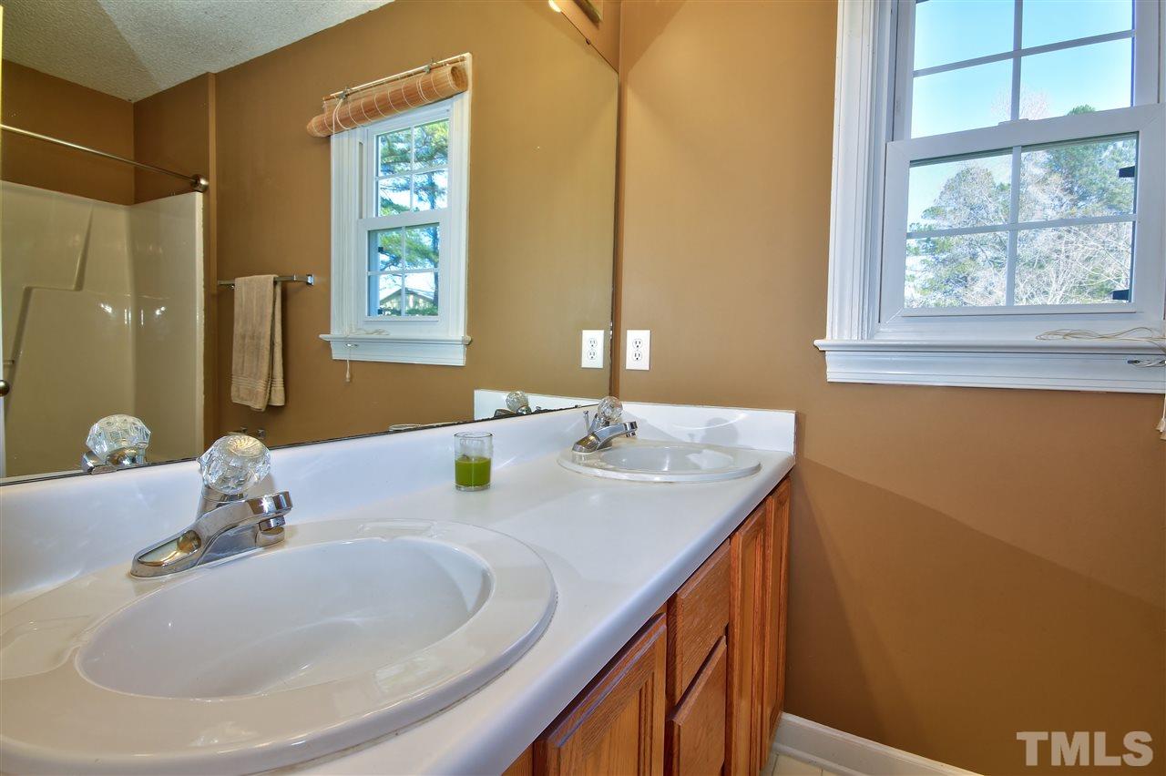 2937 Old Crews Road Raleigh, NC 27616 - Photo 6 of 19 a bathroom with a double vanity sink and a mirror
