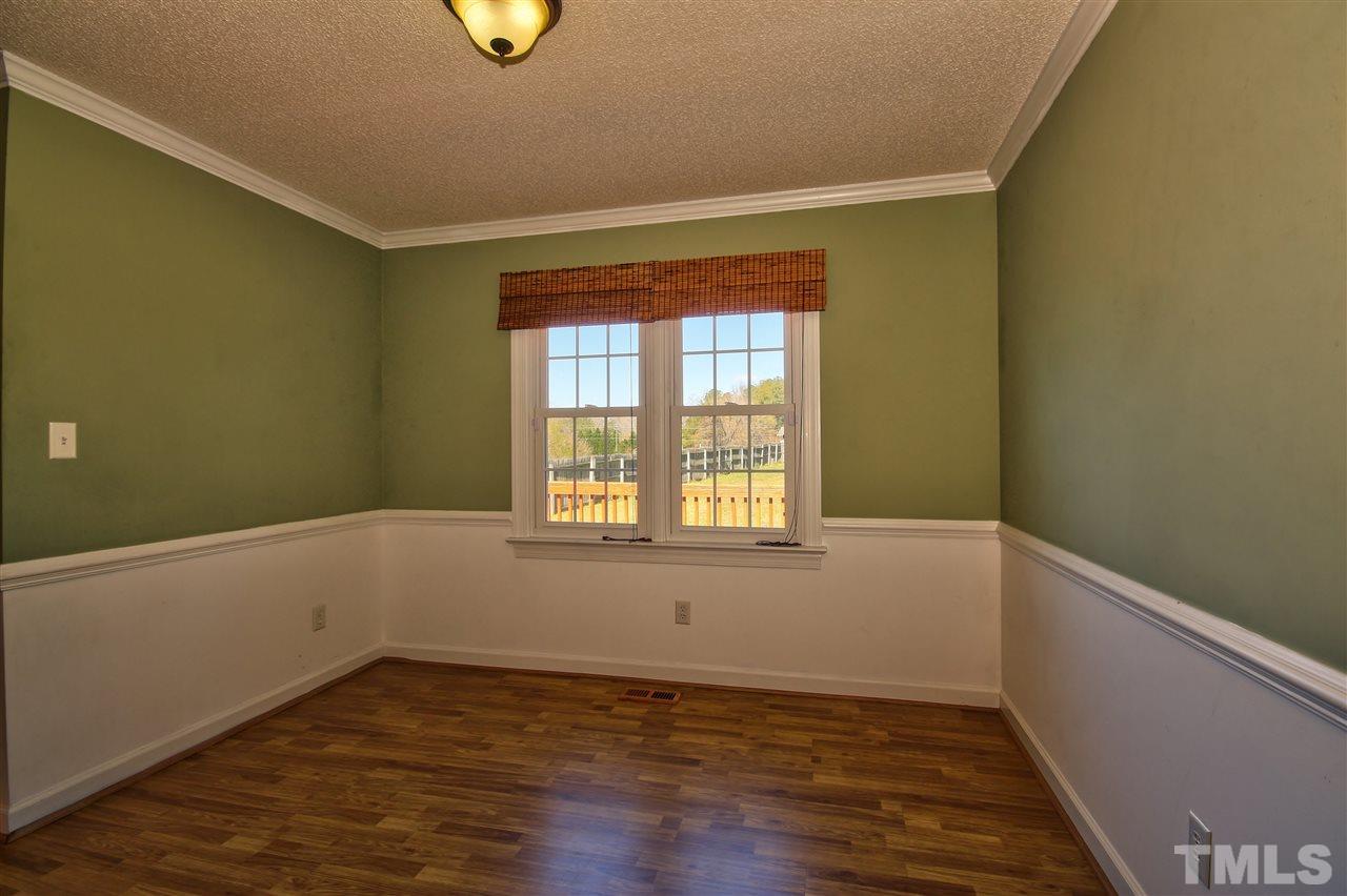 2937 Old Crews Road Raleigh, NC 27616 - Photo 7 of 19 a view of an empty room with wooden floor and a window