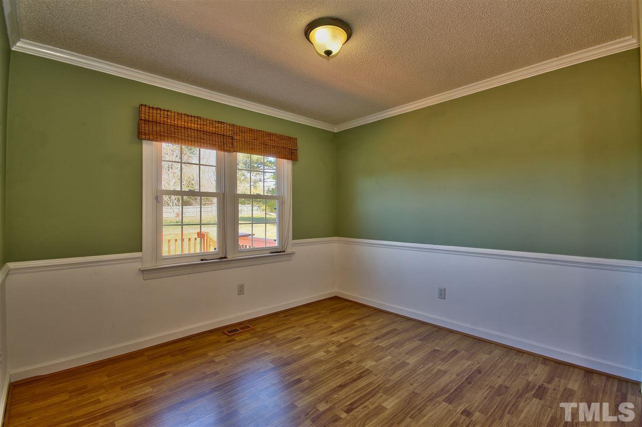 2937 Old Crews Road Raleigh, NC 27616 - Photo 8 of 19 an empty room with wooden floor and windows
