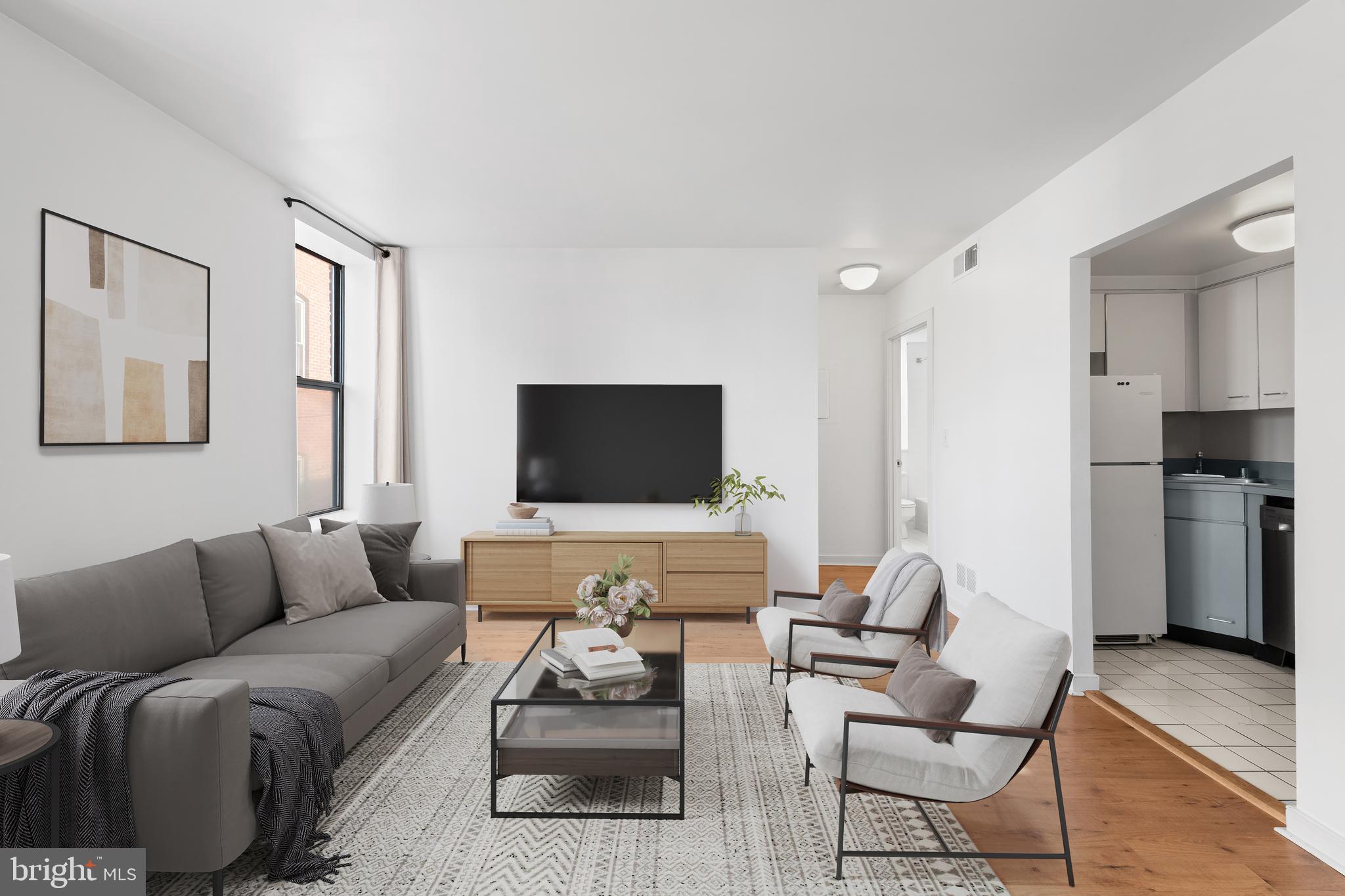2611 Adams Mill Road Northwest, Unit 208 Washington, DC 20009 - Photo 12 of 22 a living room with furniture and a flat screen tv
