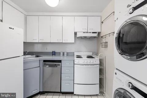 a view of a storage and utility room with washer and dryer