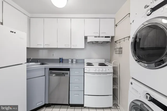 a view of a storage and utility room with washer and dryer