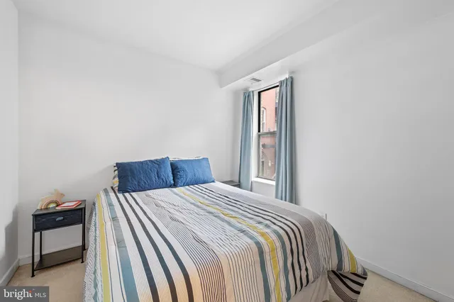 a bedroom with a bed and a chair