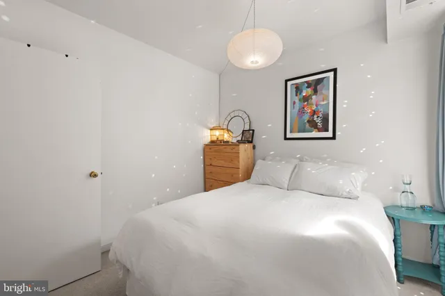 a bedroom with a bed and a glass door shower