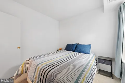 a bedroom with a bed and a large mirror