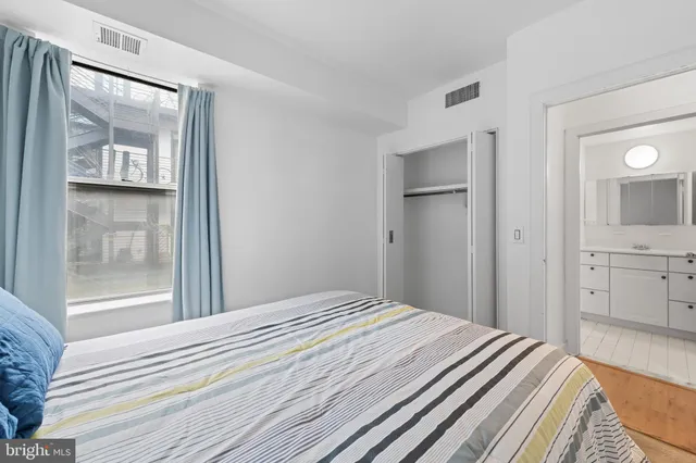 a bedroom with a bed and a shower curtain