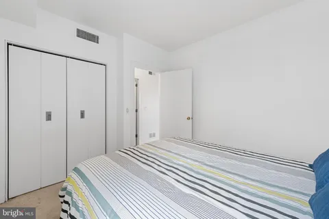 a bathroom with a toilet a sink a tub and mirror