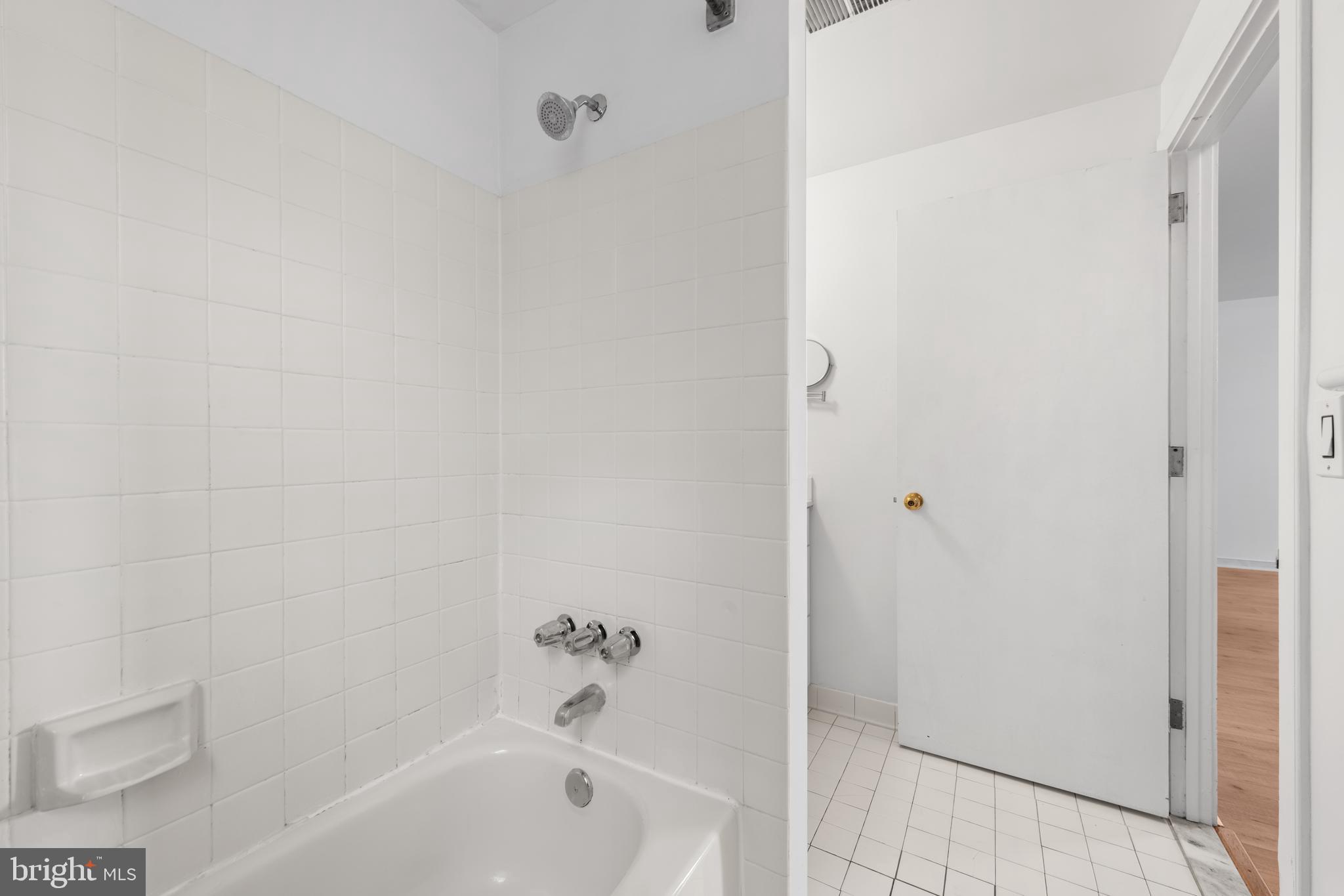 2611 Adams Mill Road Northwest, Unit 208 Washington, DC 20009 - Photo 22 of 22 a bathroom with a bathtub
