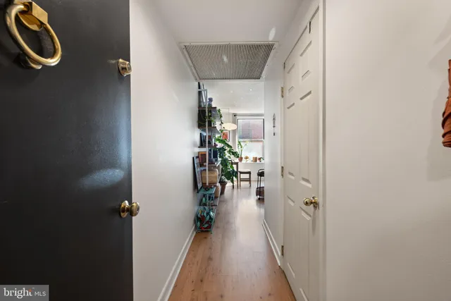 a living room with furniture a window and a flat screen tv