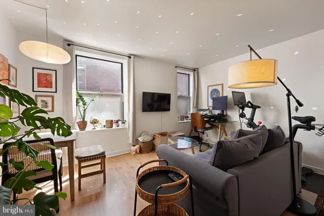 a living room with furniture and kitchen view