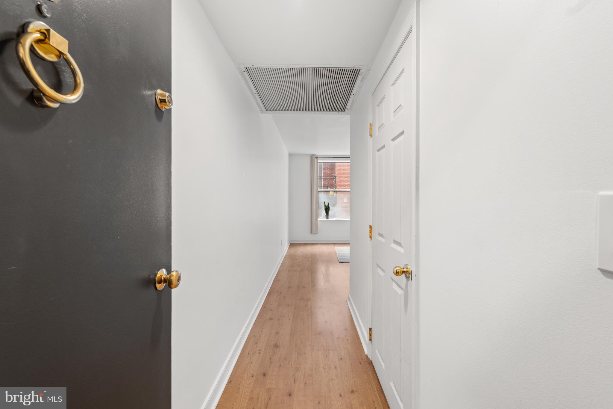 2611 Adams Mill Road Northwest, Unit 208 Washington, DC 20009 - Photo 6 of 22 a view of a hallway with wooden floor