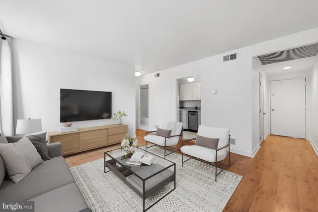 a living room with furniture and wooden floor
